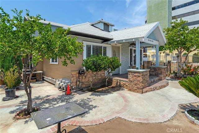 back of property featuring a patio area and fence