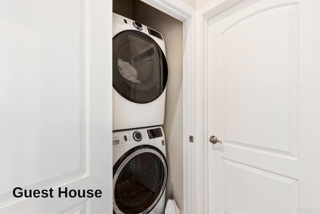 clothes washing area featuring laundry area and stacked washer and dryer