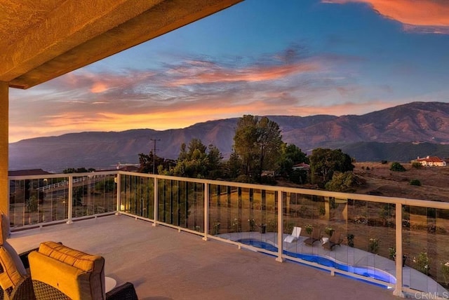 exterior space featuring a balcony and a mountain view