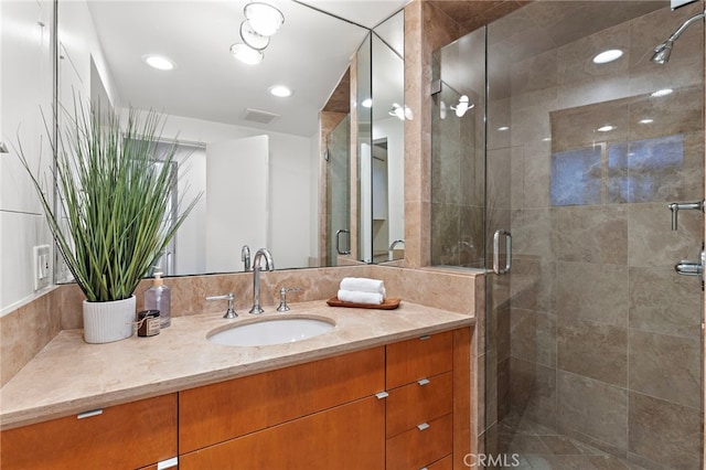 bathroom featuring recessed lighting, visible vents, a stall shower, and vanity