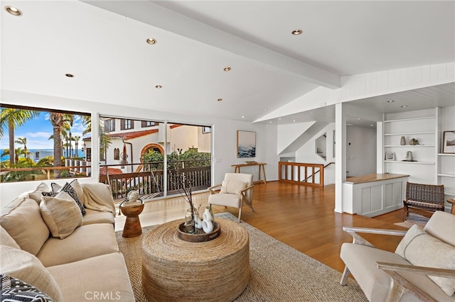 living area featuring recessed lighting, stairs, lofted ceiling with beams, and wood finished floors