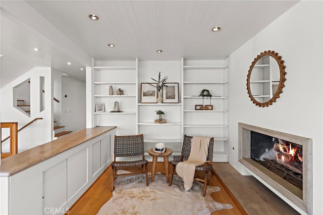 living area with light wood finished floors, a high end fireplace, stairway, wood ceiling, and recessed lighting