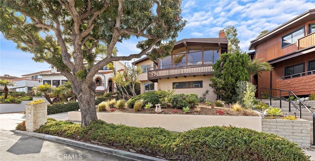 exterior space with stucco siding and a chimney