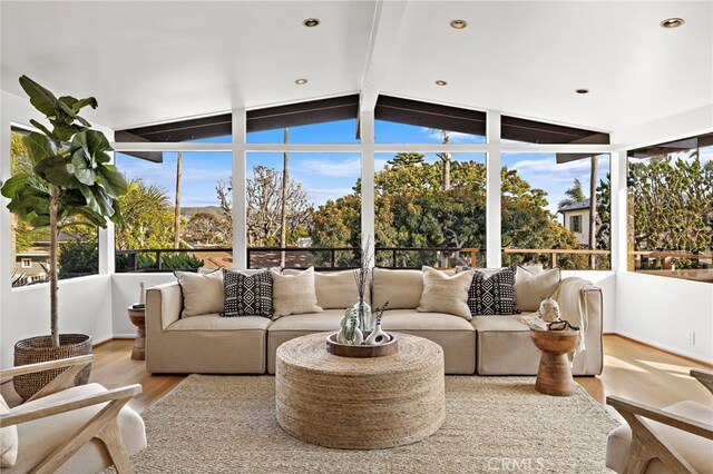 sunroom featuring lofted ceiling with beams