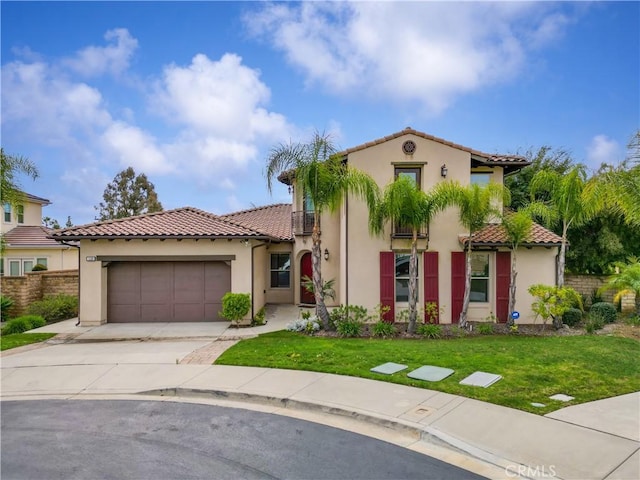 mediterranean / spanish house with stucco siding, a garage, and a tile roof