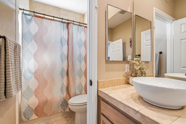 bathroom featuring tile patterned flooring, a shower with curtain, toilet, and vanity