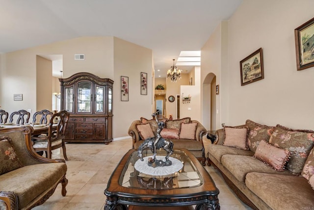 living area with light tile patterned floors, visible vents, arched walkways, vaulted ceiling, and a notable chandelier