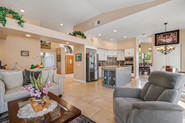 living area with visible vents, a notable chandelier, recessed lighting, light tile patterned floors, and lofted ceiling