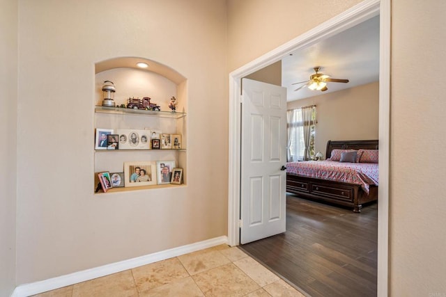 bedroom featuring tile patterned flooring, a ceiling fan, and baseboards