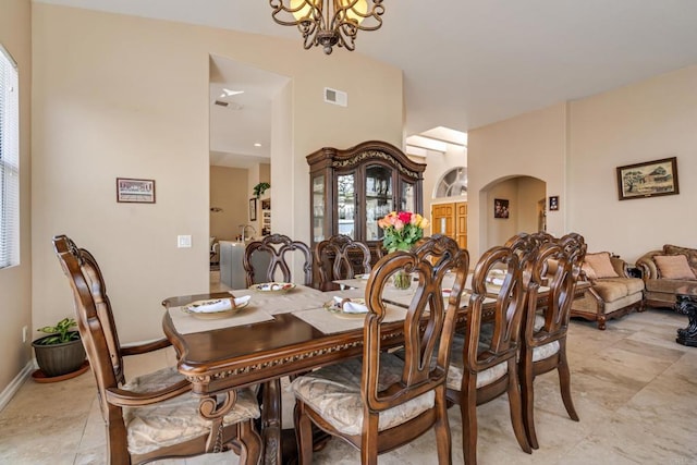 dining room with baseboards, visible vents, and a chandelier