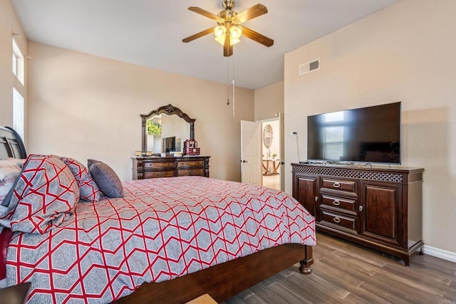 bedroom with visible vents, ceiling fan, and wood finished floors