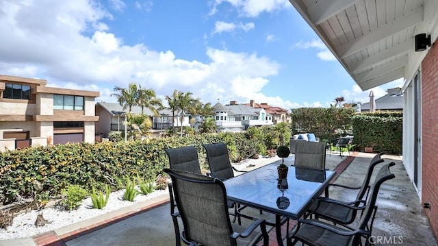 view of patio / terrace featuring outdoor dining area and a residential view