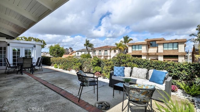 view of patio / terrace with outdoor lounge area, outdoor dining space, and french doors