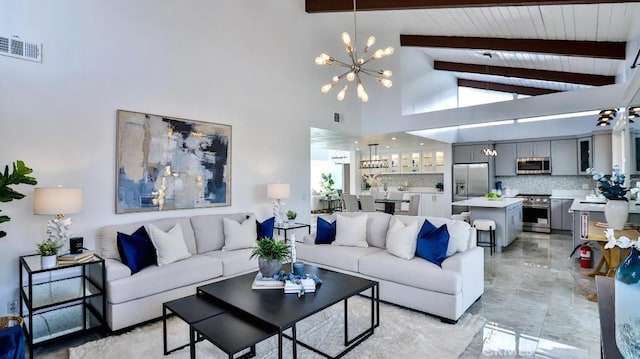 living room with beam ceiling, a notable chandelier, visible vents, and high vaulted ceiling