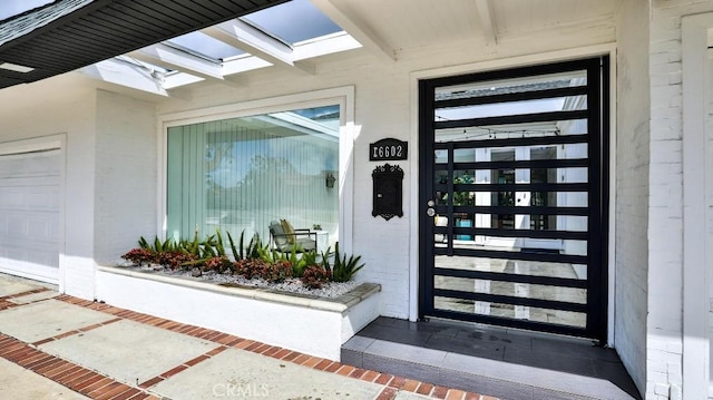 view of exterior entry with a garage