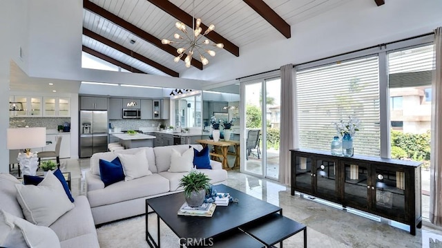 living area featuring beamed ceiling, a notable chandelier, wooden ceiling, and high vaulted ceiling