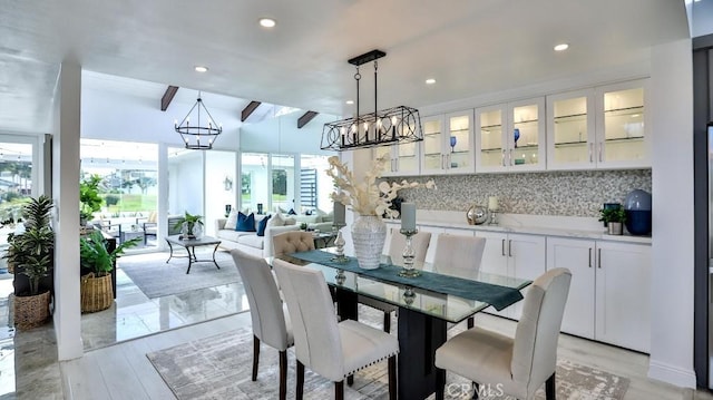 dining room featuring beam ceiling, recessed lighting, and an inviting chandelier