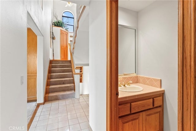 bathroom featuring backsplash, vanity, and tile patterned flooring