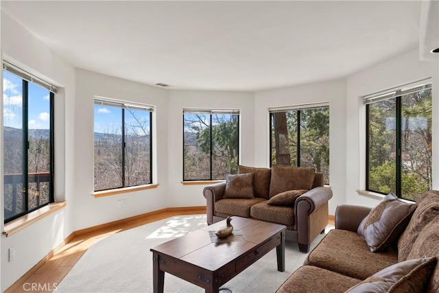 living room featuring baseboards and wood finished floors