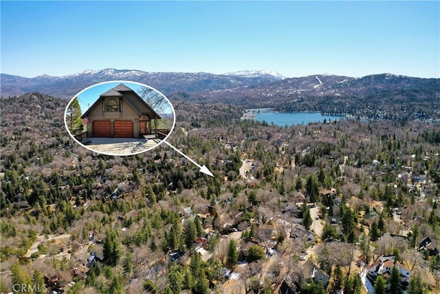 aerial view with a forest view and a water and mountain view