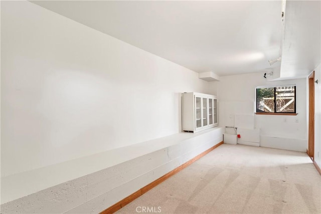 unfurnished room featuring baseboards and carpet