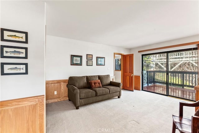 living area with light carpet and wainscoting