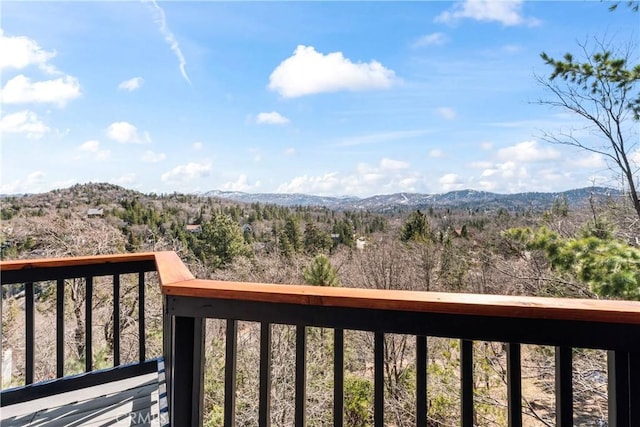 balcony featuring a mountain view and a forest view