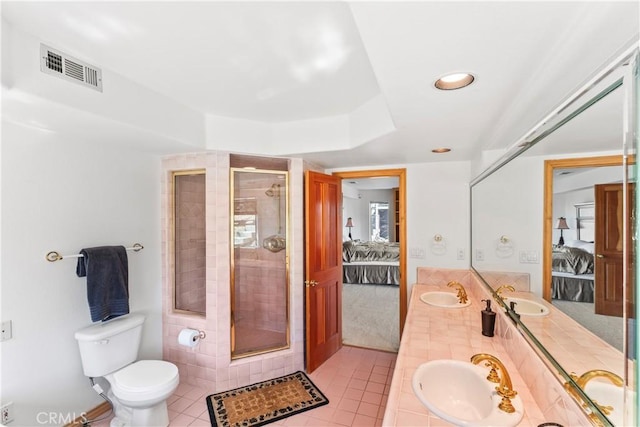 ensuite bathroom with visible vents, ensuite bathroom, and a sink