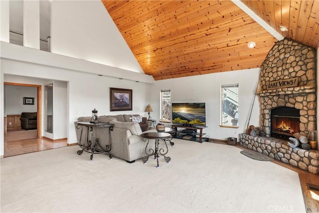 living room with a stone fireplace, wooden ceiling, and carpet