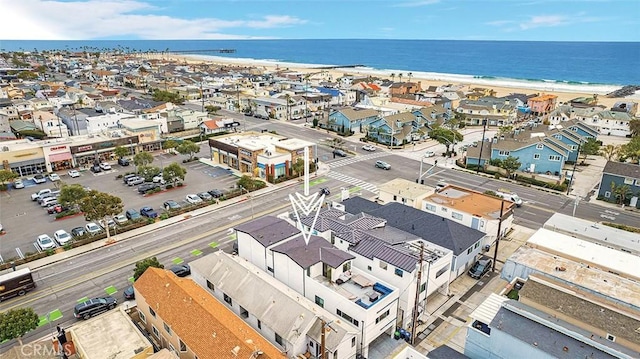 birds eye view of property with a beach view and a water view