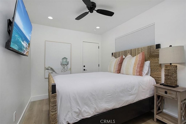 bedroom featuring recessed lighting, wood finished floors, baseboards, and ceiling fan