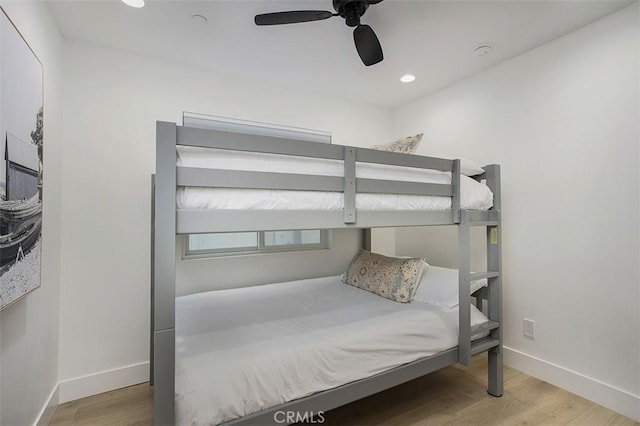 bedroom featuring recessed lighting, wood finished floors, baseboards, and ceiling fan