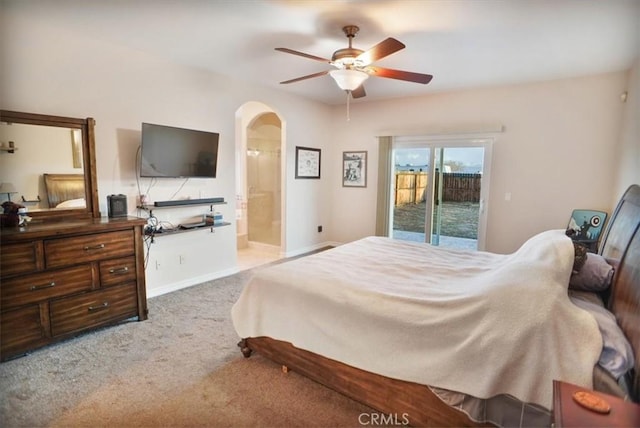 bedroom with a ceiling fan, arched walkways, carpet floors, baseboards, and access to exterior