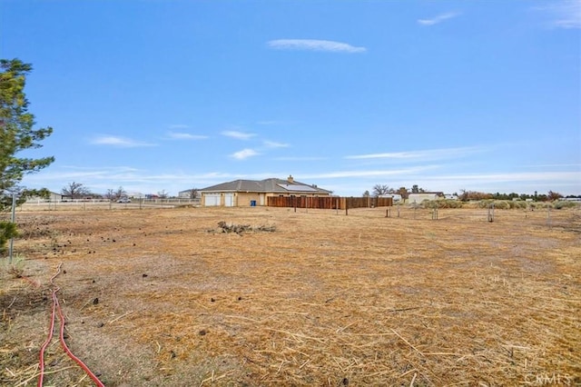 view of yard featuring a rural view and fence