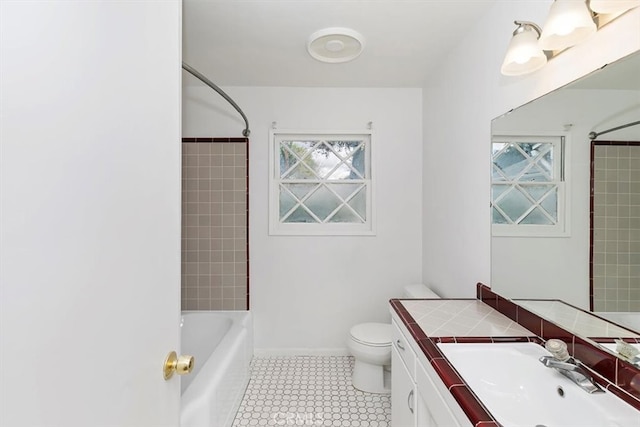 full bath featuring vanity, toilet, a healthy amount of sunlight, and baseboards