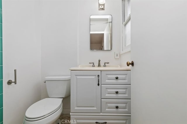 bathroom featuring vanity and toilet