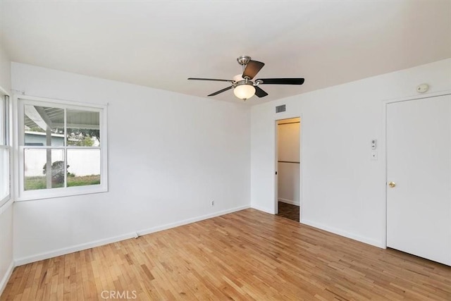 unfurnished bedroom featuring visible vents, baseboards, light wood-style floors, and ceiling fan