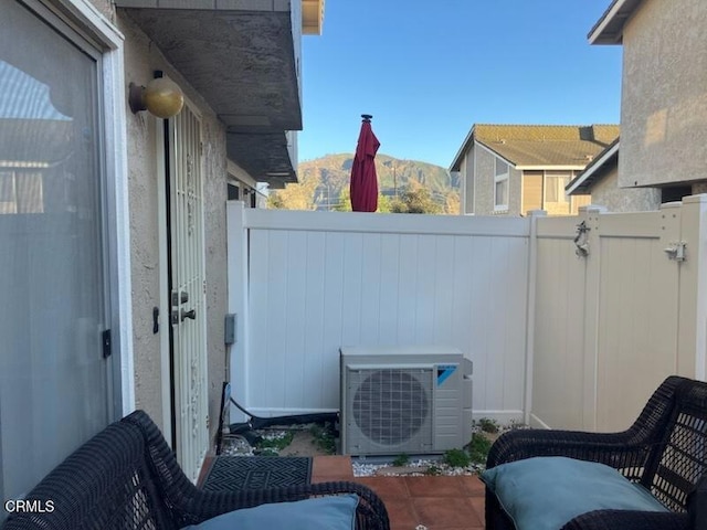 view of patio with fence and ac unit