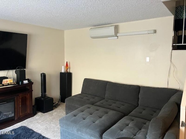 carpeted living area with a textured ceiling and a wall unit AC