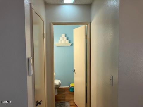 hallway with wood finished floors