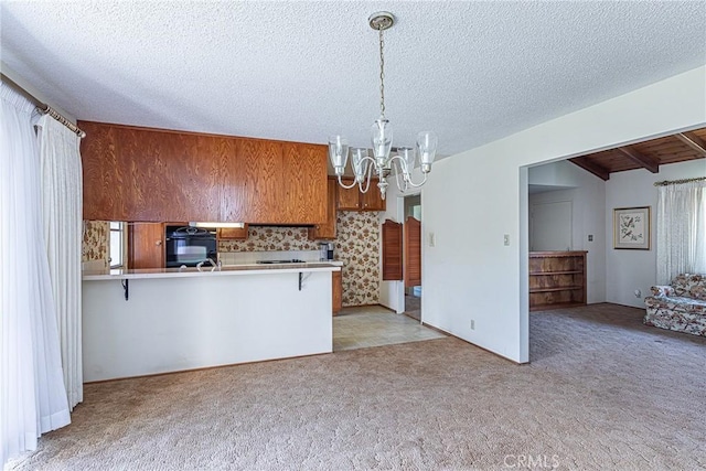 kitchen with light carpet, a breakfast bar, an inviting chandelier, brown cabinetry, and light countertops