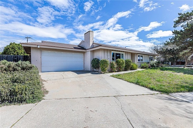 ranch-style home featuring driveway, fence, a front yard, a garage, and a chimney