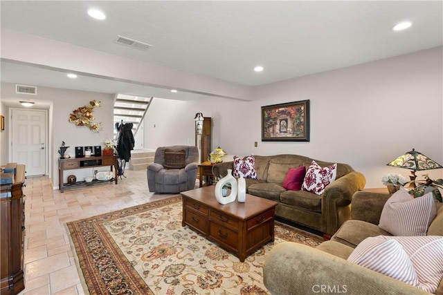 living area featuring stairs, recessed lighting, and visible vents