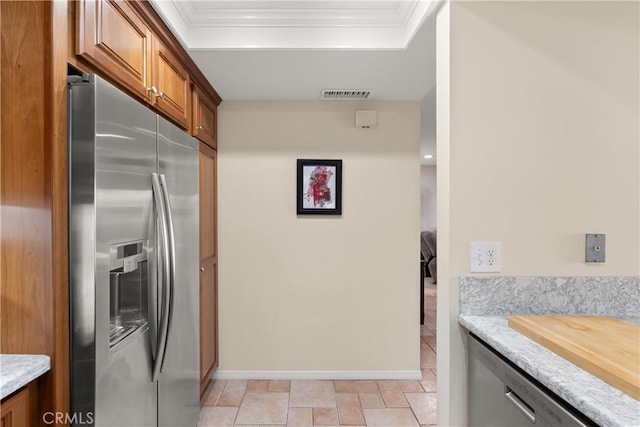 kitchen with brown cabinetry, visible vents, ornamental molding, and stainless steel fridge with ice dispenser