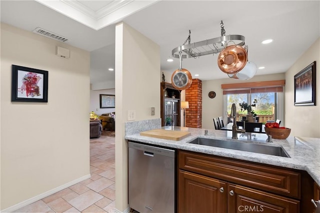 kitchen with a sink, visible vents, light stone counters, and stainless steel dishwasher