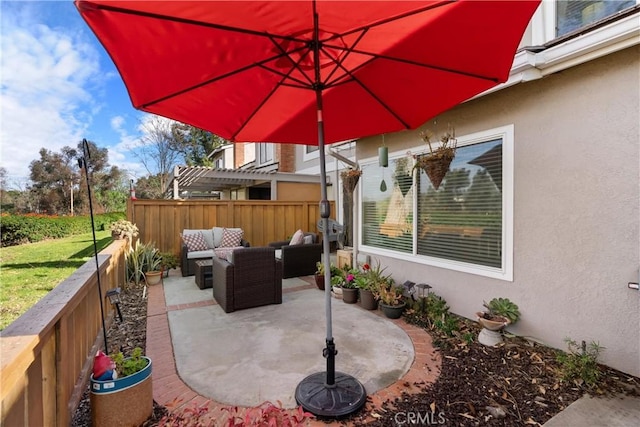 view of patio / terrace featuring an outdoor living space and fence