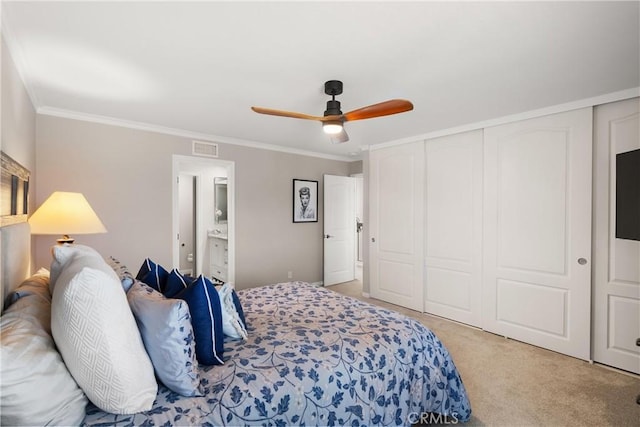 bedroom featuring visible vents, ceiling fan, ornamental molding, a closet, and light colored carpet