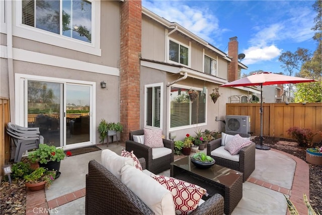 view of patio with outdoor lounge area and fence