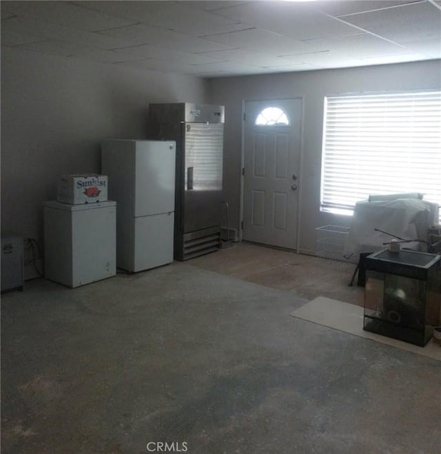 entrance foyer featuring unfinished concrete flooring