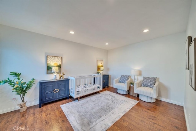 bedroom with recessed lighting, baseboards, and wood finished floors